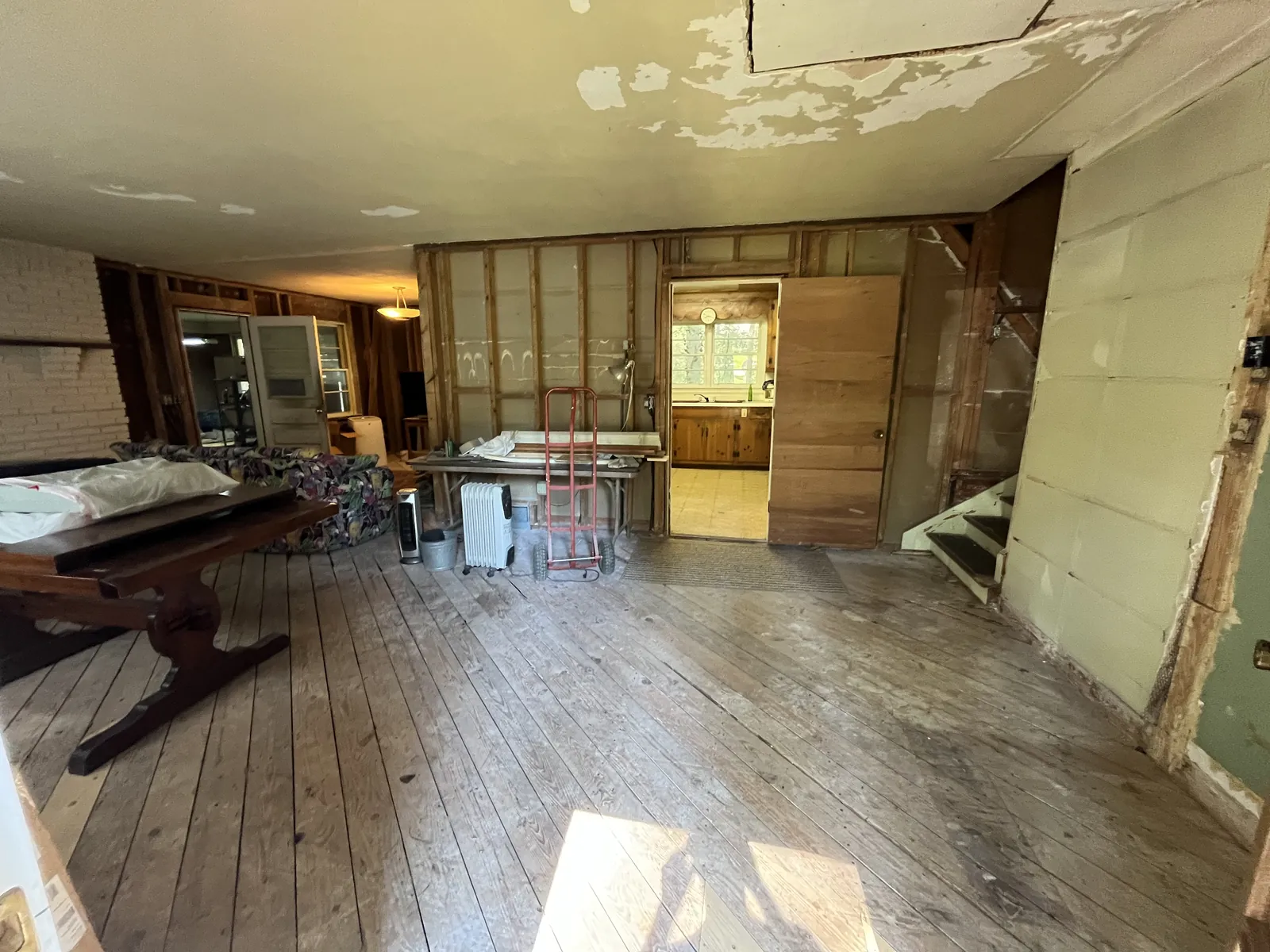 As-found interior, framing exposed and ceilings tired