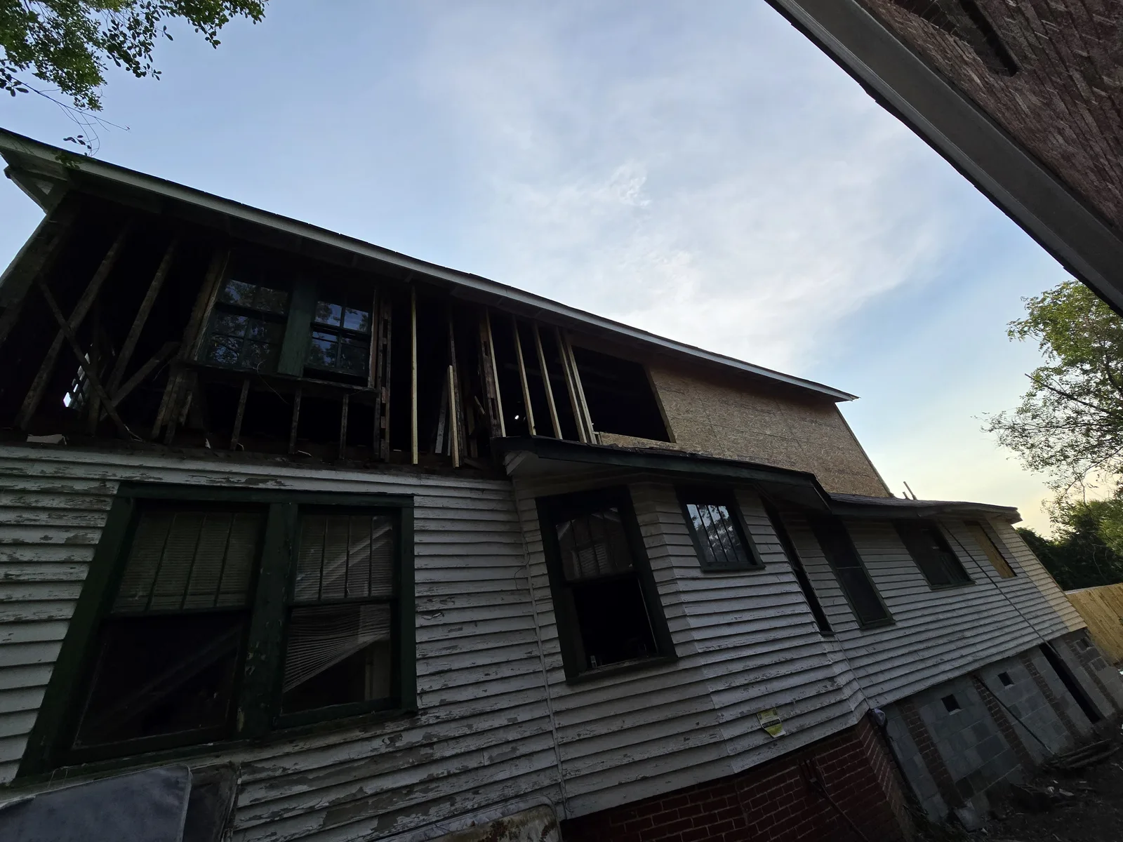 Washington Street rebuild at dusk, new framing over original siding